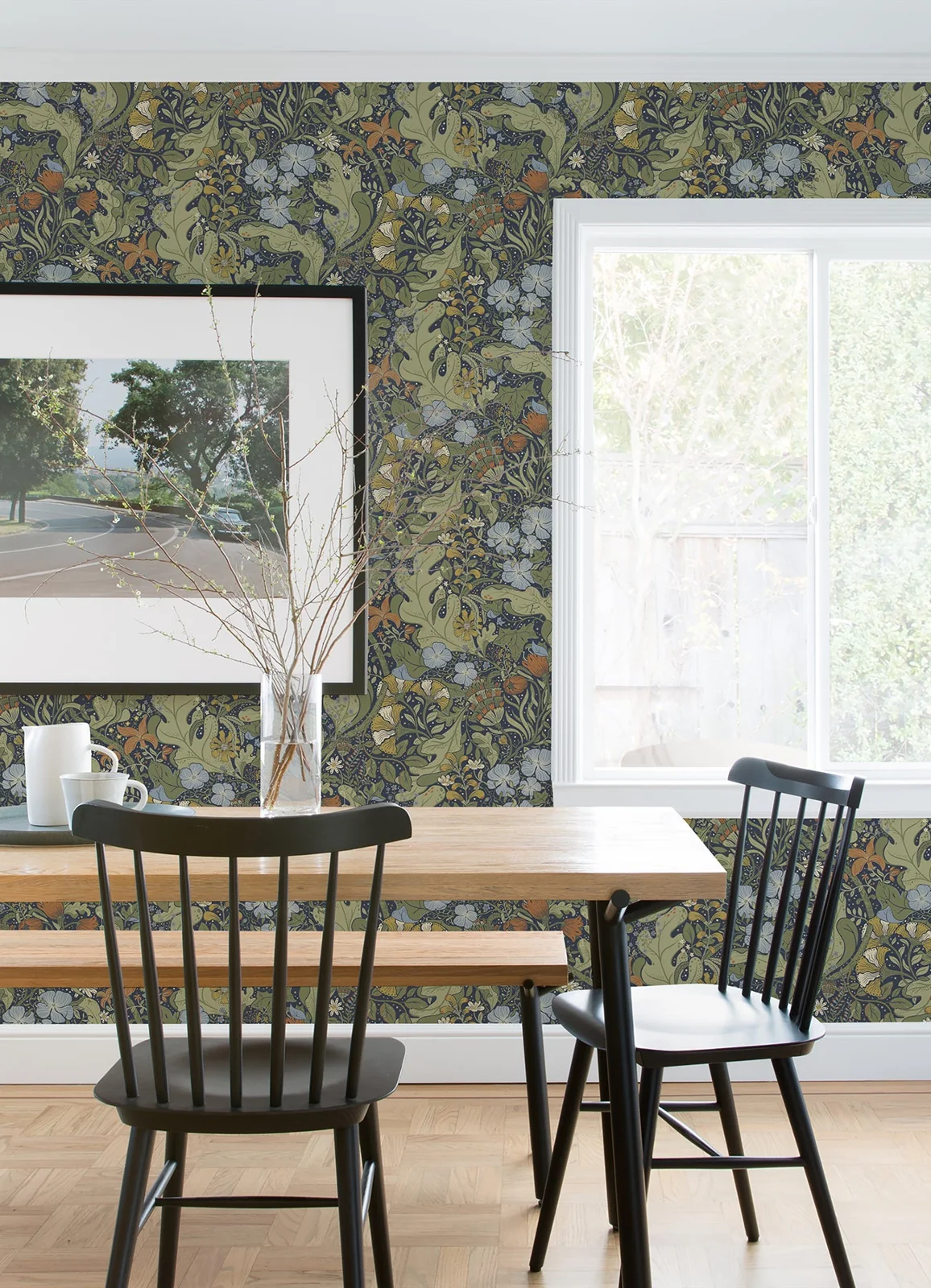 Botanical wallpaper beside a bright window in a dining room