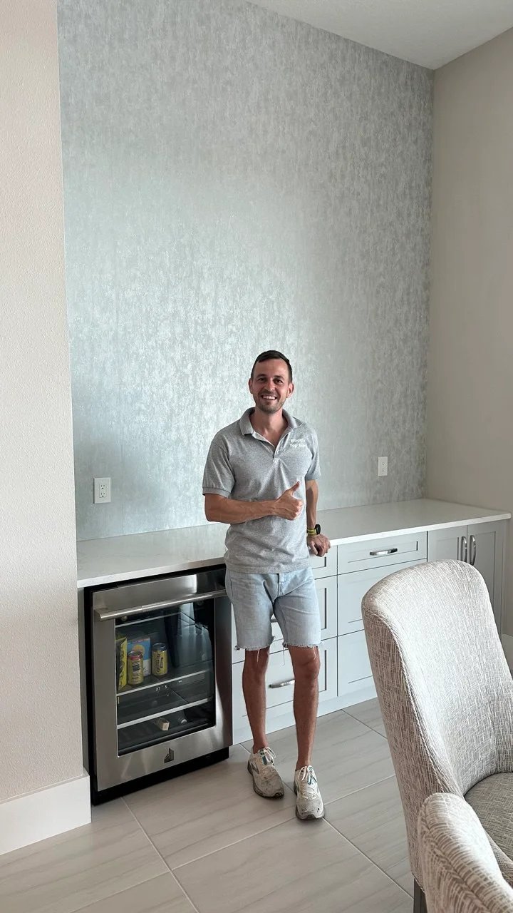 Elliott’s Top Team installer beside a completed textured wallpaper installation